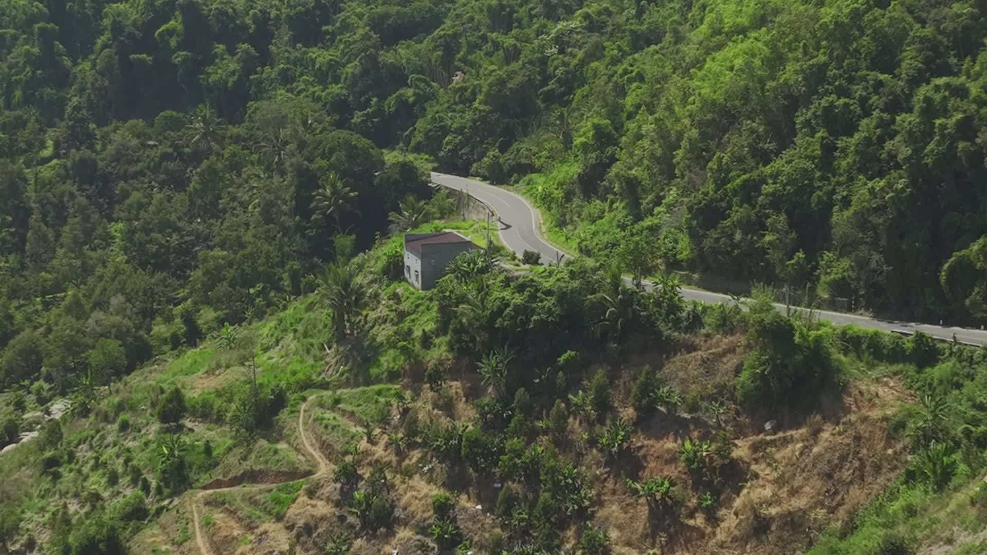 A winding road through vibrant green mountains