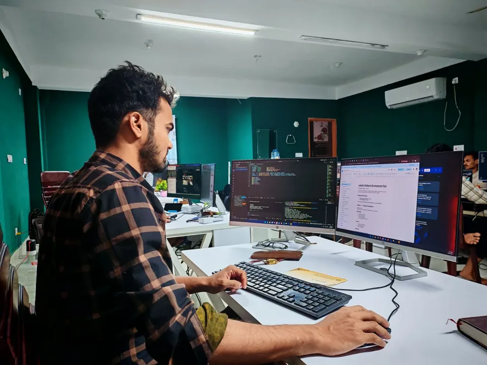 A developer working at a computer, illustrative stock photo